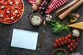 top view of uncooked pizza with blank notebook for recipe Royalty Free Stock Photo