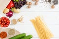 Top view of uncooked spaghetti and fresh raw vegetables and spices Royalty Free Stock Photo