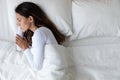 Top view unhappy depressed woman lying in bed alone Royalty Free Stock Photo