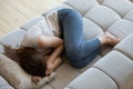 Top view unhappy depressed young woman lying on couch