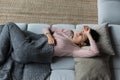 Top view unhappy woman touching forehead, lying on couch alone Royalty Free Stock Photo