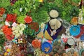 Top view of unidentified woman selling vegetables.