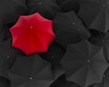 Top view of unique red umbrella standing out from the black crow Royalty Free Stock Photo