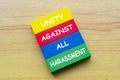 Top view of Unity Against All Harassment text on multicolored wooden blocks. Against discrimination and harassment concept Royalty Free Stock Photo