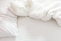Top view of an unmade bed with a pillow, a bed sheet and a blanket. Royalty Free Stock Photo