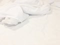 Top view of unmade bedding sheet or white fabric wrinkle texture background