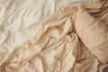 Top view of an unmade beige bed with a crumpled sheet Royalty Free Stock Photo