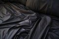 Top view of an unmade black bed with a crumpled sheet, blanket and pillows Royalty Free Stock Photo