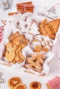 Top view of unpacked christmas present with sweets on a white textured surface, close-up