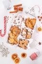 Top view of unpacked christmas present with sweets on a white textured surface, close-up