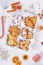 Top view of unpacked christmas present with sweets on a white textured surface, close-up