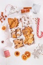 Top view of unpacked christmas present with sweets on a white textured surface