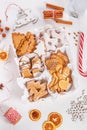 Top view of unpacked christmas present with sweets on a white textured surface