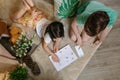 Unrecognizable children playing treasure hunt at home on the carpet