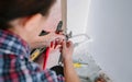 Female plumber adjusting spanner to install heating