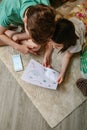 Top view of kids playing treasure hunt at home on the carpet