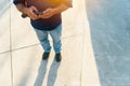 Top view of an unrecognizable latin man holding his cellphone in a park outdoors Royalty Free Stock Photo