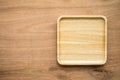 Top view of unused brand new bro wn handmade wooden dish plate on wooden table background