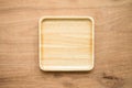 Top view of unused brand new brown handmade wooden dish plate on wooden table background