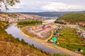 Top view of the Ural village STAROSUBHANGULOVO surrounded by the river Belaya among mountain peaks and taiga. Royalty Free Stock Photo
