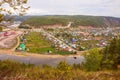 Top view of the Ural village STAROSUBHANGULOVO surrounded by the river Belaya among mountain peaks and taiga. Royalty Free Stock Photo