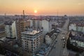 Top view of urban developing city landscape. Apartment buildings under construction, tower cranes, moving cars and suburb houses Royalty Free Stock Photo