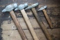 Top view used hammers of different sizes on a wooden surface. Carpentry home repair tool Selective focus