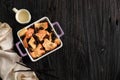 Top View Vanilla Cinnamon Raisin Bread and Butter Pudding on Square Baking Dish with Copy Space for Text. On Wooden Table Royalty Free Stock Photo