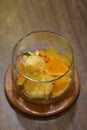 top view vanilla ice cream and orange slices in a glass bowl on a wooden tray, on wooden table background, food, dessert, copy