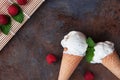 Top view vanilla ice cream in waffle cone with mint leaves on a