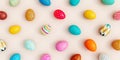 Top view on variety of colorful Easter eggs on beige background