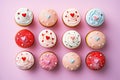 Top view of a variety of delicious cupcakes on a pink background. the perfect holiday dessert to share with someone special