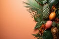 Top view with variety of fresh tropical fruits, palm leaves, pink background and empty space Royalty Free Stock Photo