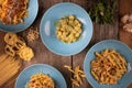 Top view variety of homemade prepared pasta isolated on wooden table