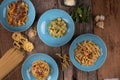 Top view variety of homemade prepared pasta isolated on wooden table
