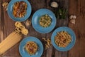 Top view variety of homemade prepared pasta isolated on wooden table