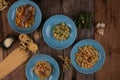 Top view variety of homemade prepared pasta isolated on wooden table