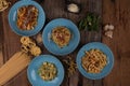 Top view variety of homemade prepared pasta isolated on wooden table