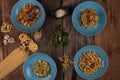 Top view variety of homemade prepared pasta isolated on wooden table