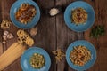 Top view variety of homemade prepared pasta isolated on wooden table