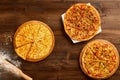 Variety of pizzas on wooden table