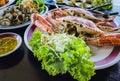 Top view of variety Seafood party table with scallop, cockle, crab, clams, shrimps, crayfish on black background. Seafood platter