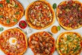 Top view of a variety of tasty pizzas with spices