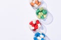 top view of various colorful pills in plastic bowls Royalty Free Stock Photo