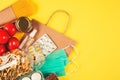 Top view on various food and medicaments with paper bag on yellow background with copy spac - pasta, fresh vegetables, canned food Royalty Free Stock Photo