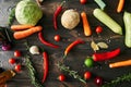 Top view of various fresh vegetables and herbs on dark wooden table Royalty Free Stock Photo