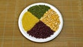 Top view of various grains in a round plate with mung beans, corn, millet Royalty Free Stock Photo