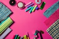 Top view with various sewing tools on pink background Royalty Free Stock Photo