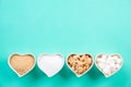 Top view of various types of sugar. Cube sugar, raw sugar brown sugar and granulated sugar in heart bowl on bright green pastel Royalty Free Stock Photo