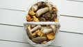 Top view of various wild mushrooms collected in wooden basket